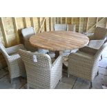 A Bramblecrest Kuta 150cm round dining table with six Patagonia armchairs and cushions