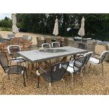 A Bramblecrest concrete/resin table with teas base and ten stacking metal chairs with cushions -