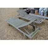 A pair of weathered sun loungers