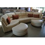 A Natuzzi cream leather suite in three pieces with two crescent footstools - Length 3.