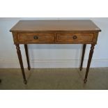 A 19th century style mahogany two drawer side table on turned reeded legs - Height 75cm x 88cm x