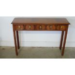 A walnut and inlaid five drawer hall table raised on square chamfered supports - made by a local