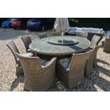 A Bramblecrest Sahara 250cm x 180cm oval table, eight side chairs and two armchairs, lazy susan,