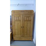 A 1930's large stripped pine two door wardrobe,