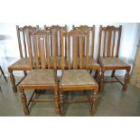 A set of six oak dining chairs with carved dolphin top rails on bulbous supports