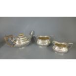 A silver bachelors three piece tea set - teapot and bowl Birmingham 1911/12 - jug Chester 1911/12 -