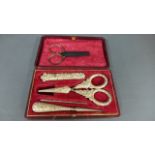 A small white metal sewing kit boxed missing thimble with additional scissors