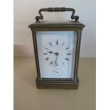 A brass four glass carriage clock with alarm striking on a bell - Height 14cm - working in the sale