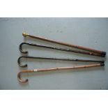 Four assorted walking sticks,