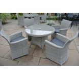 A Bramblecrest all weather Allegra 100cm round table with four armchairs,