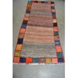 A hand knotted woolen Gabbeh rug - 1.57m x 0.