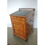 A good quality early 19th century walnut davenport with sliding top and galleried back,