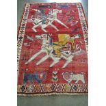 A hand knotted woolen Shiraz rug - 1.73m x 1.