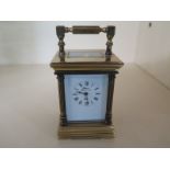 A small brass carriage clock with French movement in five glass panel case - Height 11cm x 5.