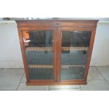 A late Victorian/Edwardian mahogany glazed two door bookcase - Height 123cm x 121cm x 23cm