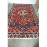 A hand knotted woolen Persian rug - 2.90m x 1.