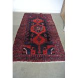 A hand knotted woolen Afshar rug - 2.43m x 1.