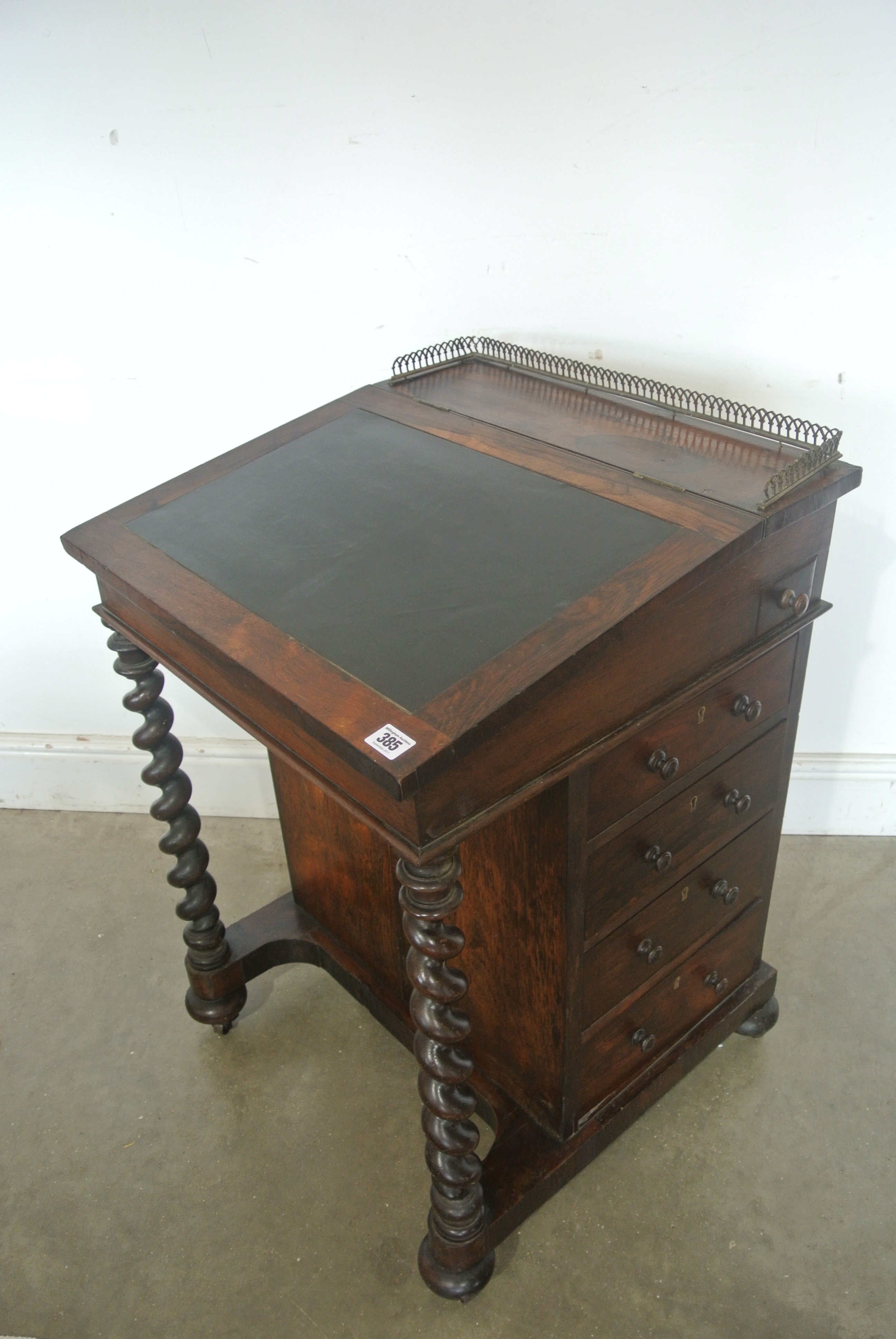 A Regency rosewood writing Davenport opening to reveal a maple fitted interior,