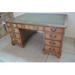 An early 1900's mahogany partners desk with nine drawers and opposing three drawers above two