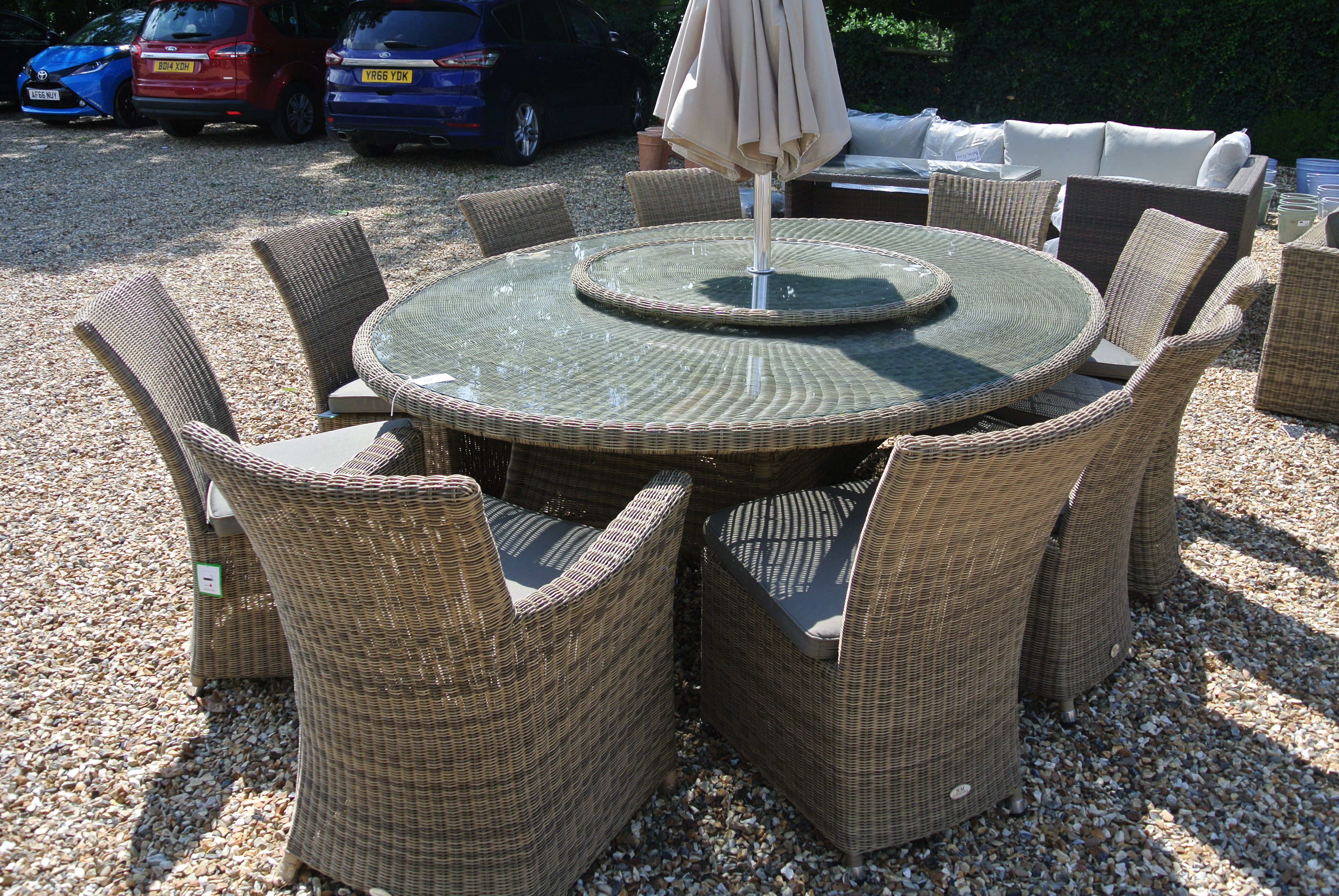 A Bramblecrest Sahara 250cm x 180cm oval table, eight side chairs and two armchairs, lazy susan,