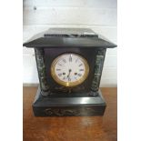 A slate and marble mantle clock striking on a bell,