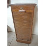 An oak Lebus filing cabinet with a tambour front and rising top - Height 119cm x 49cm x 43cm