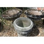 A pair of weathered stone effect garden urns - Height 39cm - and another urn