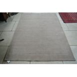 A beige contemporary woolen rug - 230cm x 160cm