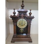 A continental striking walnut and pine mantle clock - 55cm