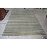 A green ground and stripped pattern contemporary rug