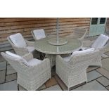 A Bramblecrest all weather Amberley 150cm round table with six chairs,