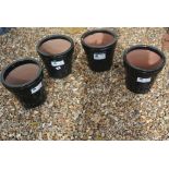 A set of four glazed plant pots in black - Height 24cm