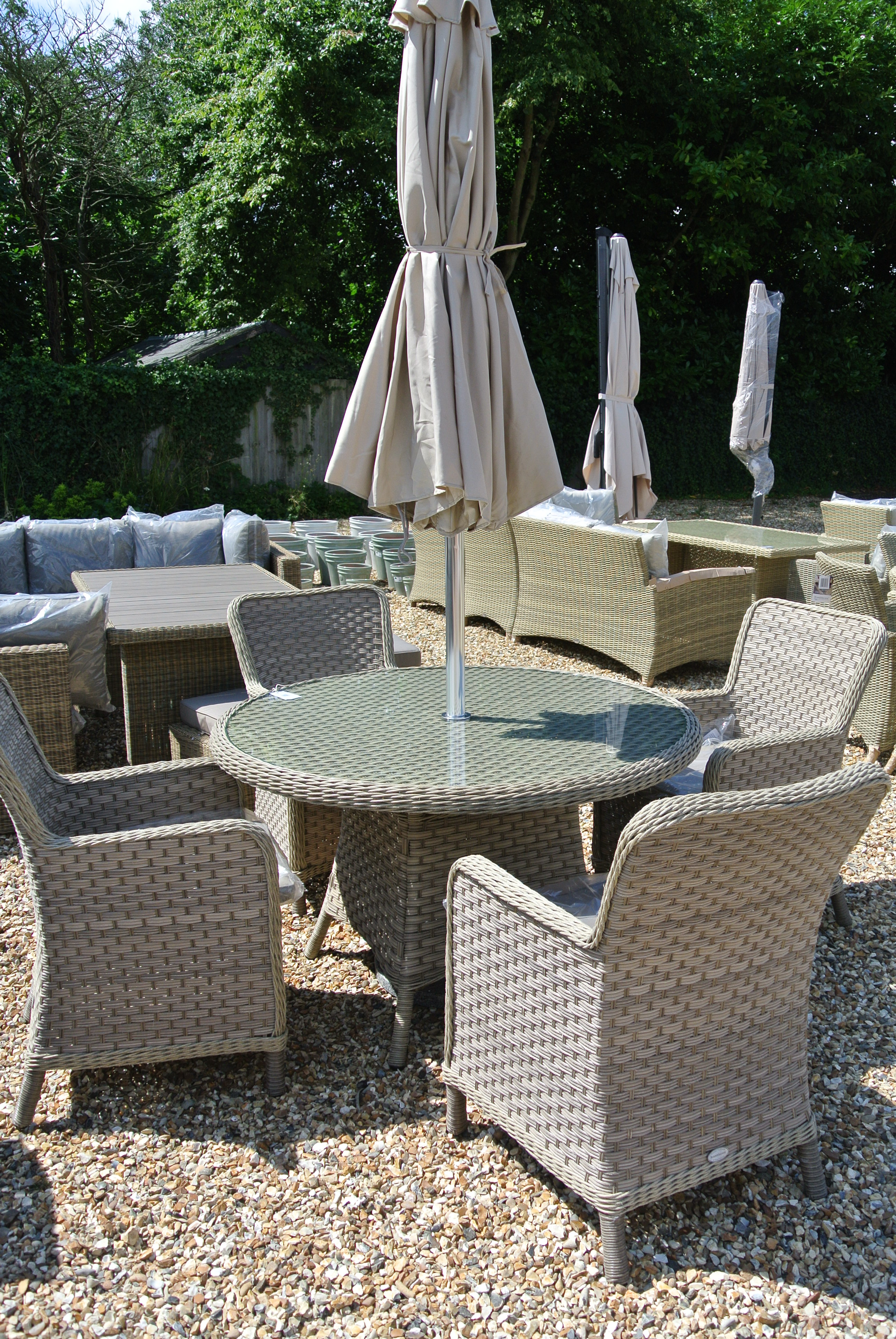 A Bramblecrest Patagonia four seat dining set with parasol and base- One bent chair