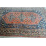 An Oriental rug measuring 245cm x 183cm