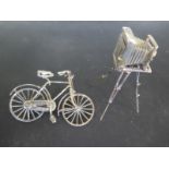 A hallmarked silver miniature camera on tripod stand and a miniature bicycle approx 2 troy oz -