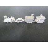 A hallmarked silver miniature train with candle holding positions,