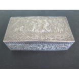 A white metal box with hinged lid and embossed figural decoration