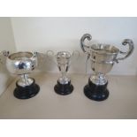 Three hallmarked silver trophy cups, all on plinth bases, approx weight 7.