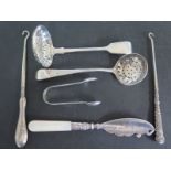 Two hallmarked silver strainer ladles, a pair of sugar nips,