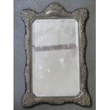 A hallmarked silver surround, bevelled mirror plate to centre,