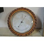 An oak Aneroid Barometer with Thermometer - 28 cm diameter