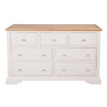 A new Aspen painted three short over four long drawer chest - finished in a mushroom colour with an