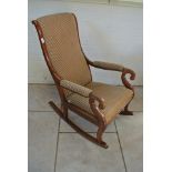 A 19th Century mahogany scroll arm rocking chair recently upholstered