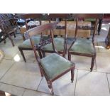 A set of four 19th Century mahogany dining chairs with reeded legs and drop in seats