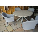A Bramblecrest all weather concrete top table with four fabric dining side chairs