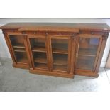 A 19th Century mahogany break front bookcase with three glazed doors enclosing adjustable shelves -