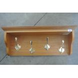 An oak coat rack with brass hooks - 29cm tall x 75cm x 20cm