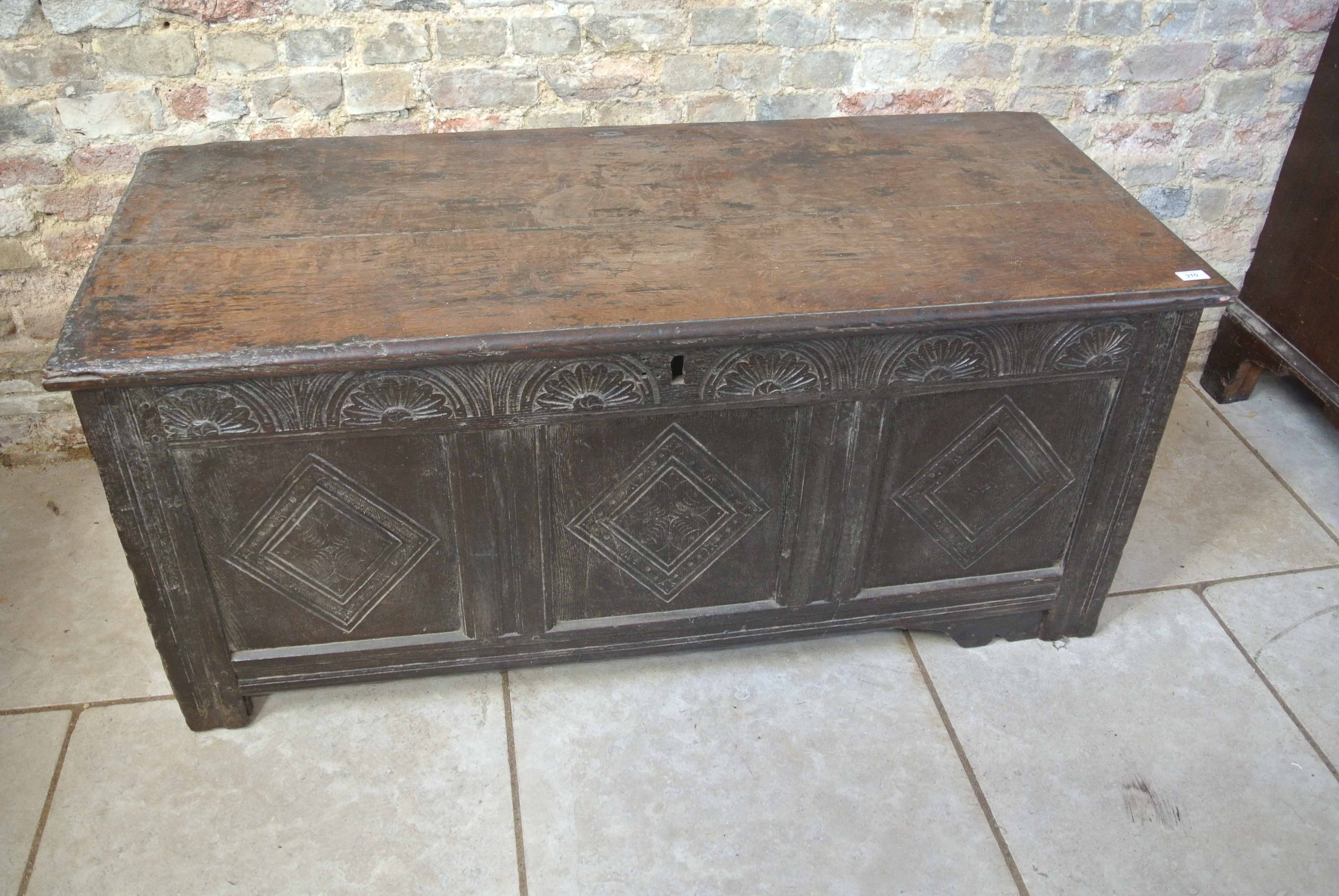 An 18th Century oak coffer with a carved front - 64cm tall x 138cm wide - some wear mainly to the