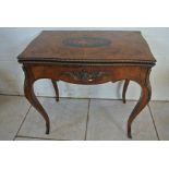 A 19th century walnut foldover games table with a marquetry inlaid top having chess board and card