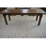 An 18th Century elm refectory table with a good patina and a three plank top,